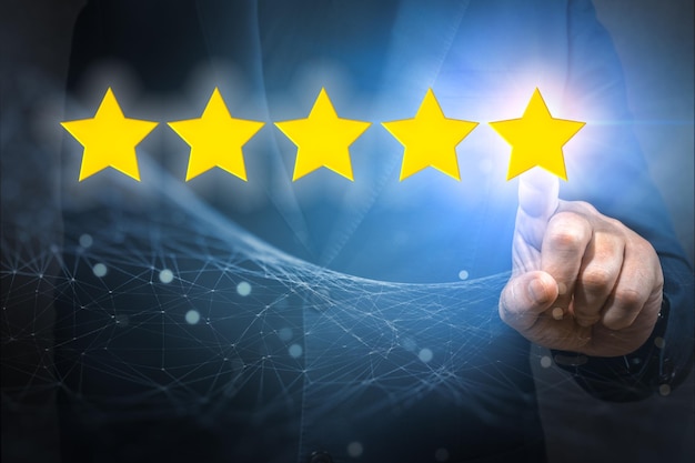 Businessman pointing five star symbol to increase rating of company Customer satisfaction and product service evaluation concept Increase rating