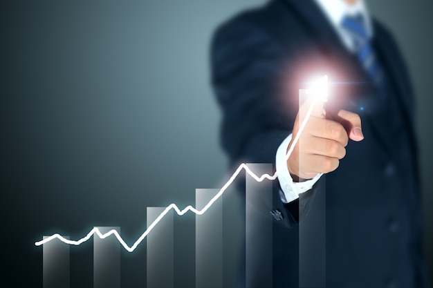 businessman pointing graph of success