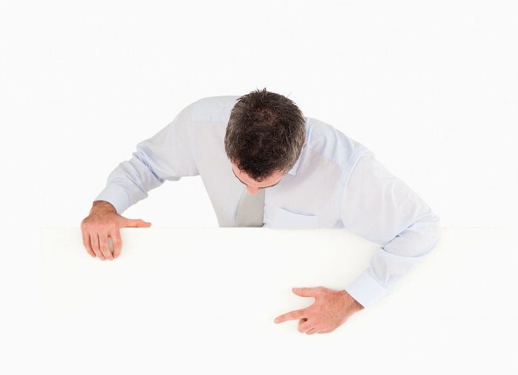 Photo businessman pointing at something on a blank panel