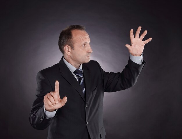 Businessman pointing at a virtual point. photo on black background