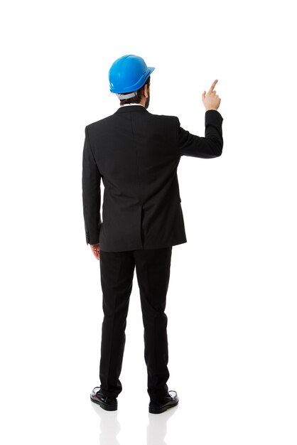 Businessman pointing while standing against white background