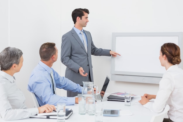 Businessman pointing the white screen