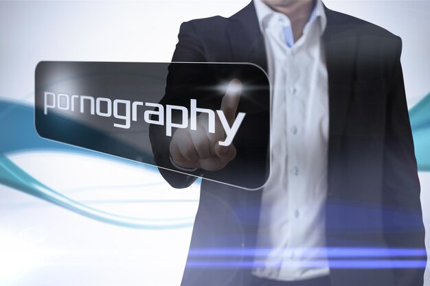 Businessman pointing to word pornography against abstract blue line son white background