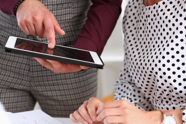 Businessman points a finger at the tablet