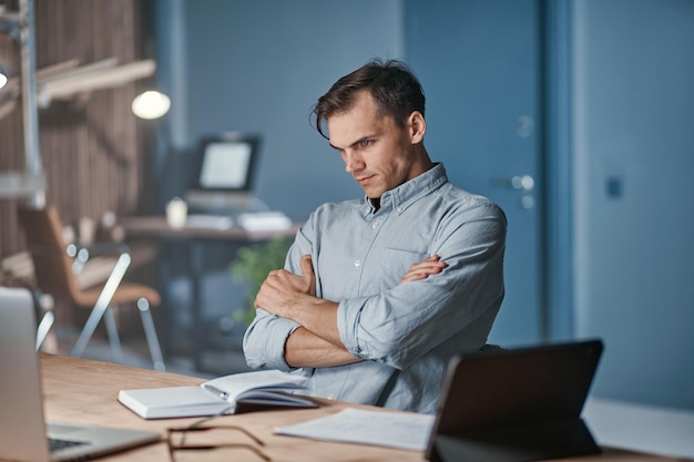 Businessman pondering a new project late at night