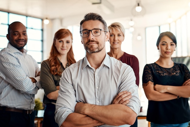 Businessman portrait and arms crossed in management leadership or executive team at office Confident business people or professional standing in confidence for teamwork or about us at workplace