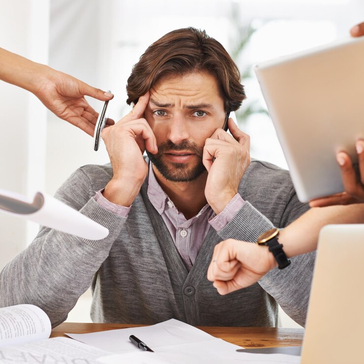 Photo businessman portrait and overworked with hands chaos and frustrated in workplace for multitasking male person headache and overworked with digital tech documents and technology for deadline time
