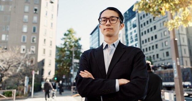 Businessman portrait and professional in city street as broker in financial market confident or Tokyo Male person face and corporate career travel at business building or Japan pride or sidewalk