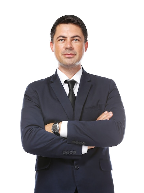 Businessman posing with crossed arms on white