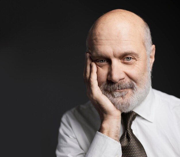 Businessman posing with hand on chin