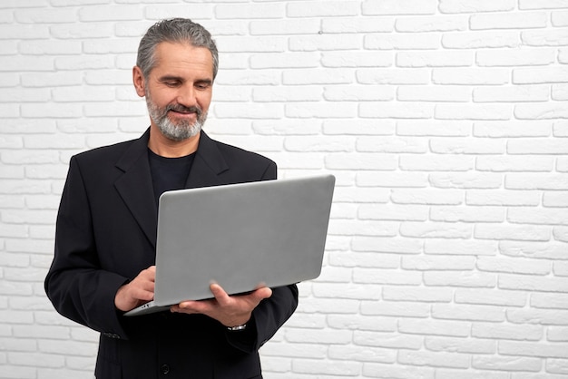 Businessman posing with notebook in studio.