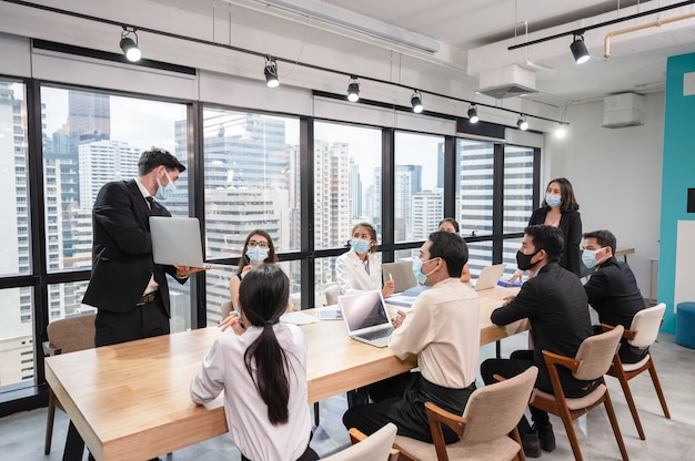 businessman presentation of business plan on laptop at conference table