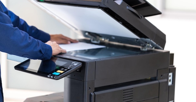 Businessman press button on panel of printer photocopier\
network working on photocopies in the office concept printer is\
office worker tool equipment for scanning and copy paper