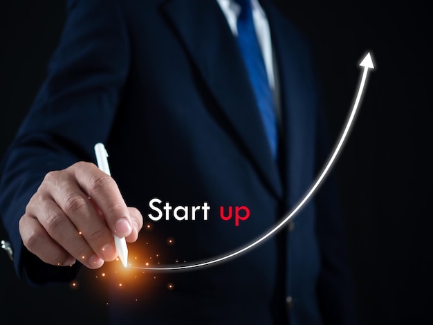 Businessman presses the pen at the starting point to start a business Startup concept Business concept