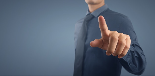 Businessman pressing button virtual screen. Hand pointing futuristic interface