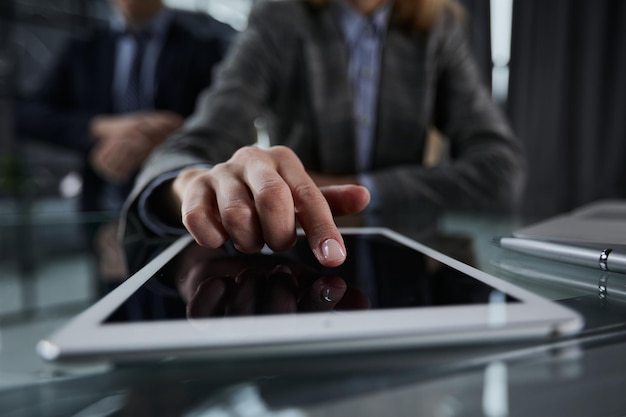 businessman pressing his finger on the screen of the digital tab