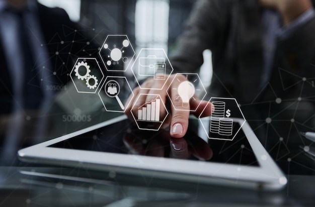 Businessman pressing his finger on the screen of the digital tab