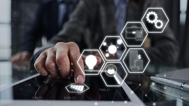 Businessman pressing his finger on the screen of the digital tab