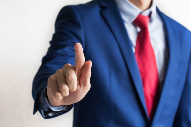 Businessman in professional suit touching on virtual screen stance