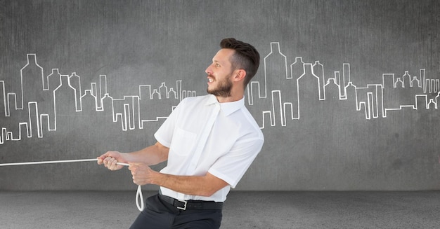 Businessman pulling rope in room with city drawings