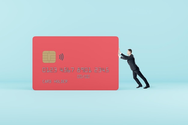 Businessman pushing black credit card on gray background Debt and loan concept