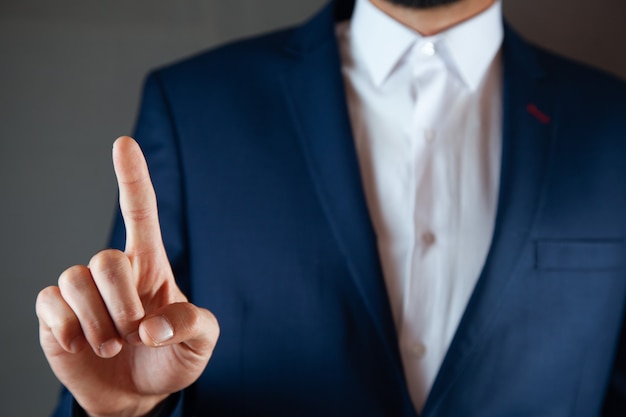 Businessman pushing on a touch screen interface