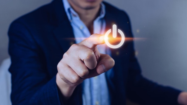 Uomo d'affari che spinge il pulsante di accensione del touch screen visivo con la struttura della sua rete di ditapremendo a mano il pulsante di accensione