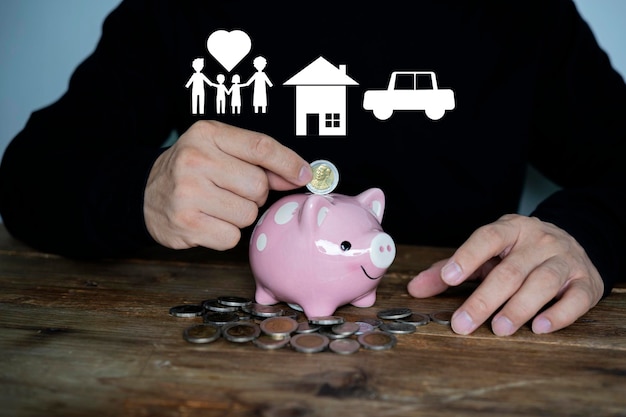 Businessman putting coin into the piggy bank