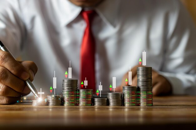 Photo businessman putting down money pointing with pen and showing candlestick symbol for investing finance saving money interest rate or dividend investment business growth concept