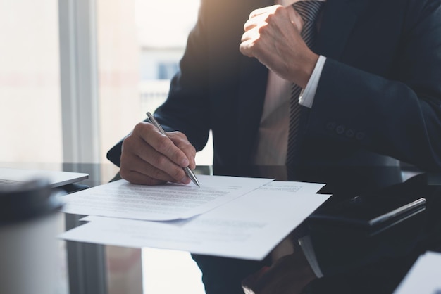 Photo businessman reading before signing official business contract formal document at modern office