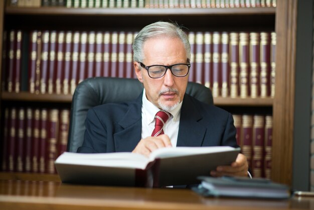 Businessman reading a book in his studio