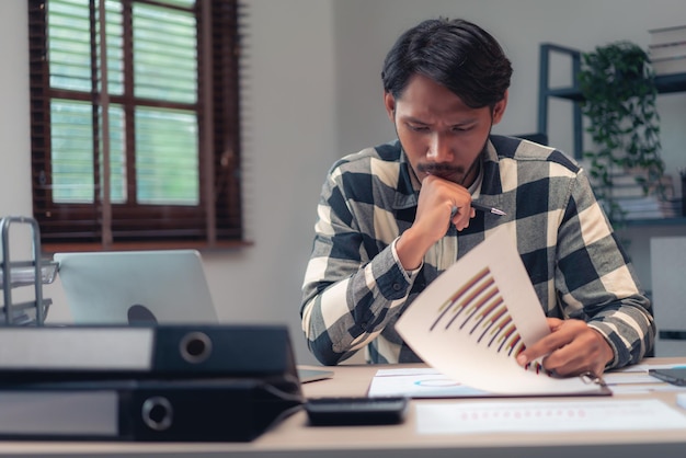 Businessman reading to checking financial and accounting report to thinking about plan of business