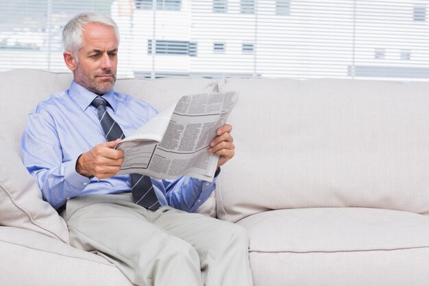 Businessman reading newspaper