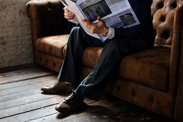 Businessman reading newspaper