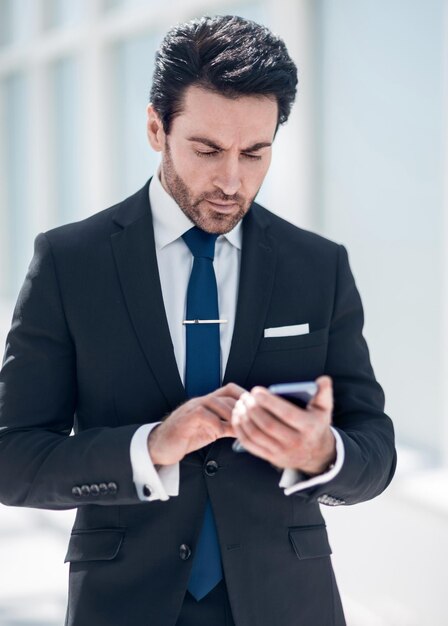 Businessman reading text message on smartphone