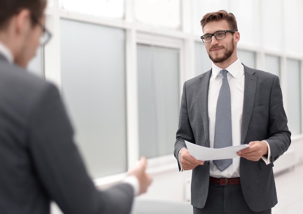 Businessman reading a working paper standing in the office