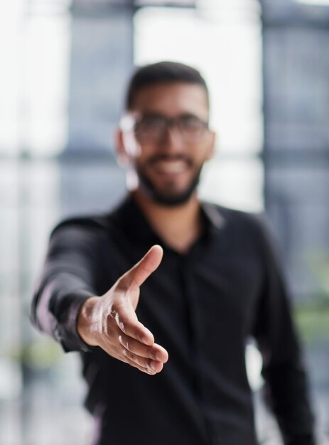 Businessman ready to shake hand in office