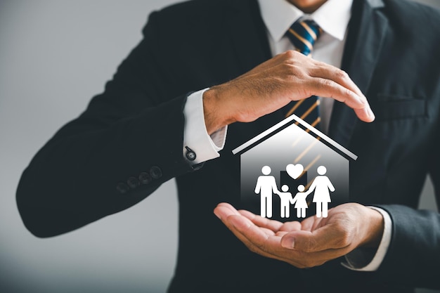 Businessman reassuring gesture highlights family safety life health and house insurance icons Insurance concept is vividly depicted along with family life insurance and policy concepts