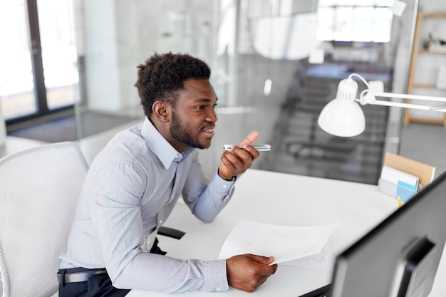 Photo businessman records voice by smartphone at office