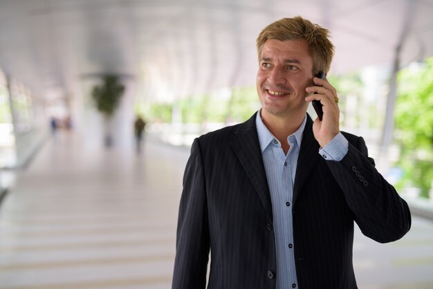 Businessman relaxing at the footbridge