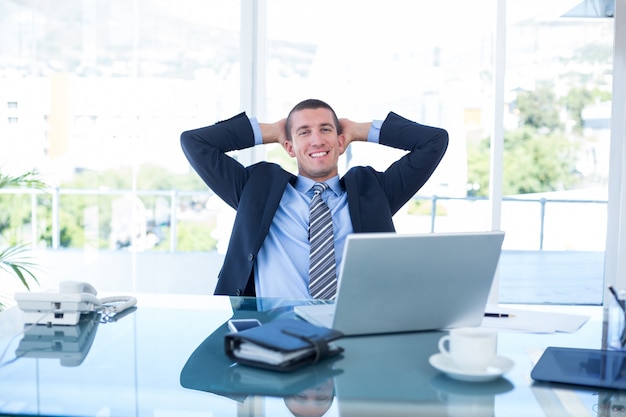 Businessman relaxing in a swivel chair 