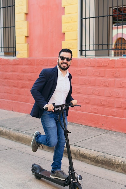 A businessman riding his E-Scooter in the city