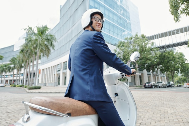 Businessman riding scooter