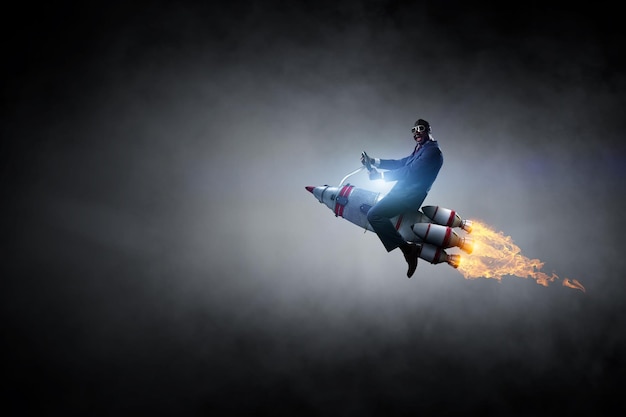 Businessman on a rocket. Mixed media