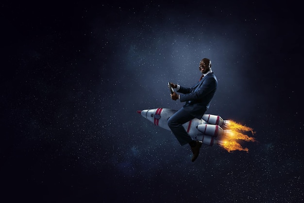 Businessman on a rocket. Mixed media