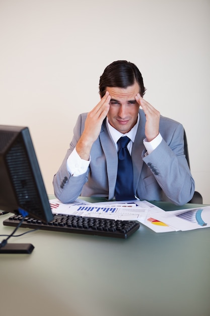 Businessman rubbing his temples