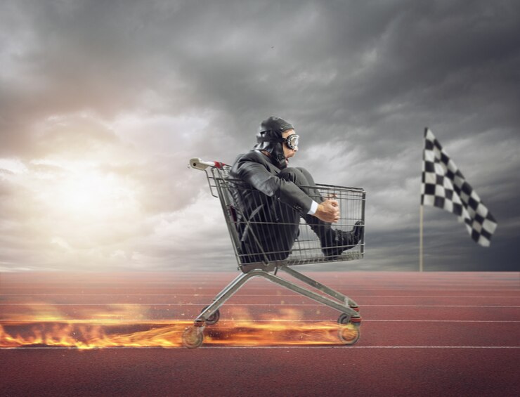 Photo businessman runs fast driving a cart on fire during a competition