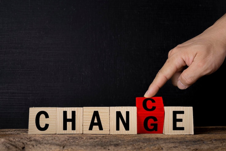 Photo a businessman's hand flips over a red wooden cube whose word has been changed to opportunity word change transforms to chance