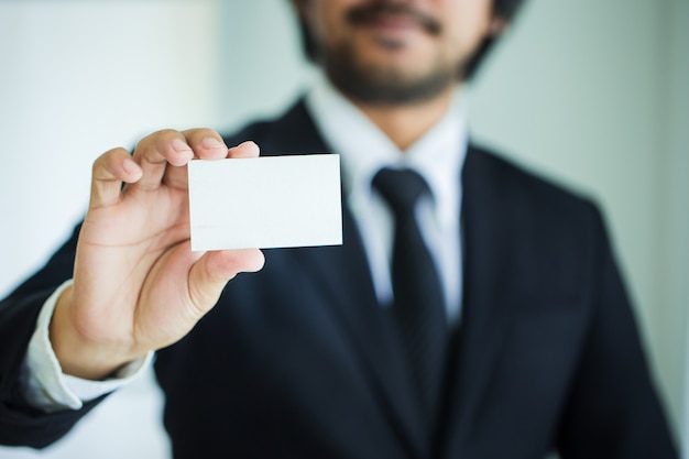 Businessman's hand showing business card