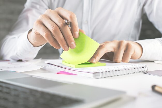 Businessman's hand writing in notepad